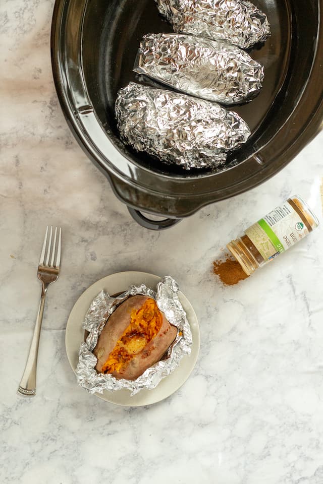 How to make the best and easiest slow cooker baked sweet potatoes – no oven  or clean up required! My favorite way to cook sweet potatoes!