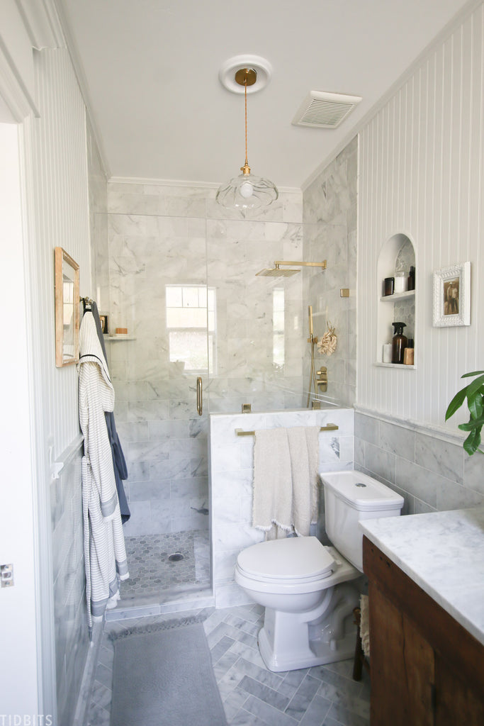 Tour our newly finished master bathroom reveal, featuring marble, gold, vintage wood and other beautiful organic raw textures.